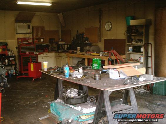 Messy garage interior with tools and parts on a workbench