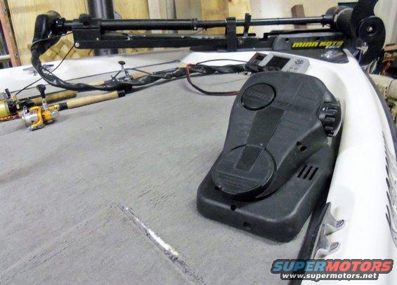 Boat deck with trolling motor, fishing rods, and control pedal