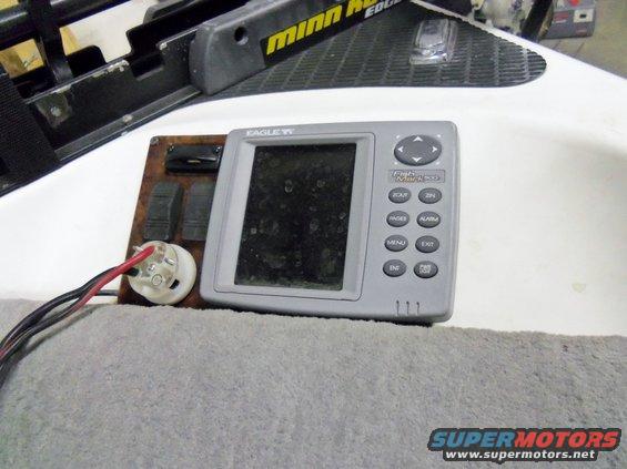 Eagle fish finder unit with buttons and wiring, next to a Minn Kota trolling motor mount