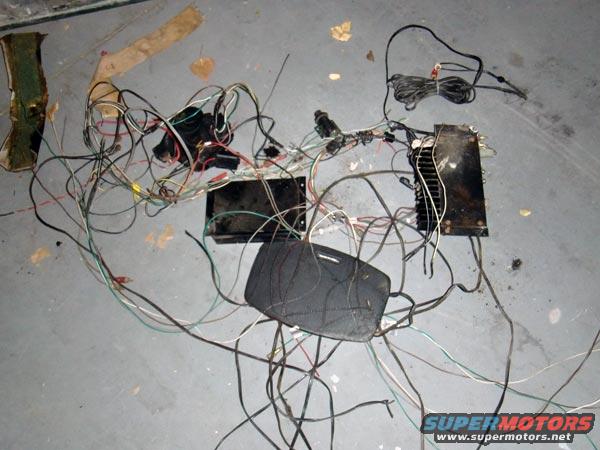 Car wiring harness and electronic components spread on a concrete floor