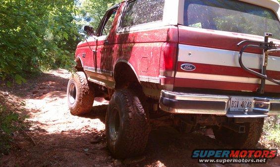 1987 Ford Bronco rear view, red and white, off-roading
