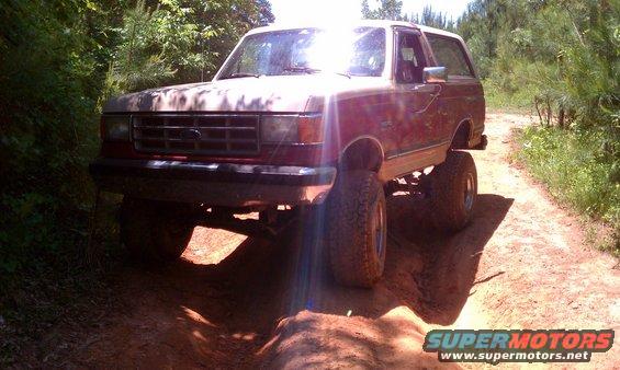 Ford Bronco on a dirt trail, front quarter view