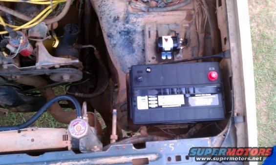 Engine bay showing a battery and various engine components
