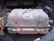 1986 Ford Bronco - A fuel tank is shown in the cargo area of a vehicle, placed on a protective mat.