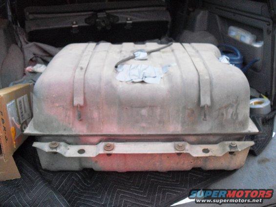 Gas tank with straps, inside a vehicle cargo area