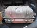 1986 Ford Bronco - A gas tank is shown inside the cargo area of a vehicle, resting on a protective mat.
