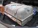 1986 Ford Bronco - Fuel tank with visible straps and duct tape repairs, resting on a quilted mat.