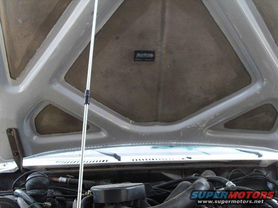 Under the hood of a 1986 Ford Bronco, showing the engine and hood insulation