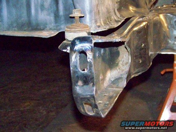 Close-up of a metal bracket attached to a vehicle frame, possibly for suspension