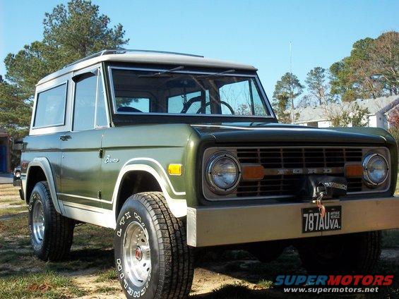Green 1979 Ford Bronco, 3/4 front view. White roof and trim
