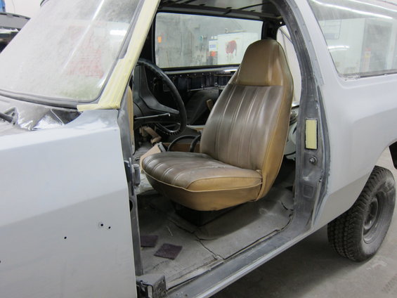 1987 Dodge 1500 interior with tan bucket seat and dashboard