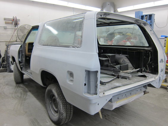Dodge Ramcharger bodywork being prepped for paint, rear view. Doors are open, interior is stripped