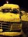 1994 Ford Bronco - A dark colored Ford Bronco is covered in snow, with other vehicles visible in the background.