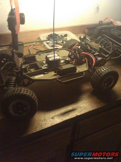 Remote control car chassis with exposed wiring and large tires
