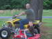2006 Honda TRX 400 EX - A man and a child are posing on ATVs in a grassy area with trees in the background.