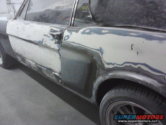 1966 Ford Mustang side panel with body filler and primer