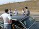 1968 Mercury Cougar - A group of men stand around a classic 1968 Mercury Cougar on a sunny day.