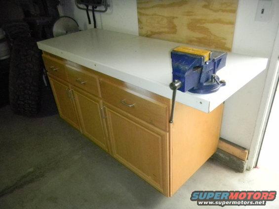 Workbench with blue vise attached to the right side