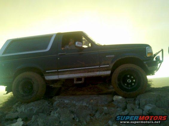 1993 Ford Bronco side view, driving over rocks