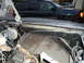 1987 Ford F-150 - The foreground shows the complex wiring of a vehicle's engine bay, with a dark SUV visible in the background.