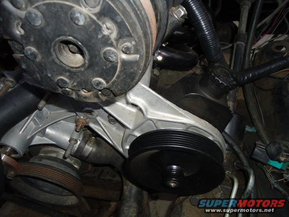 Engine water pump and pulley assembly with black hose and wiring
