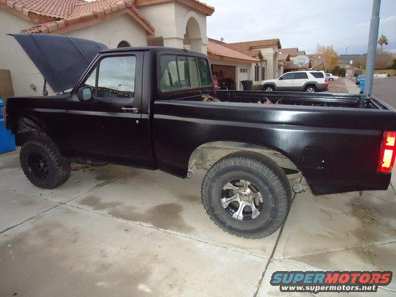 Black 1987 Ford F-150 pickup truck, side view, hood open