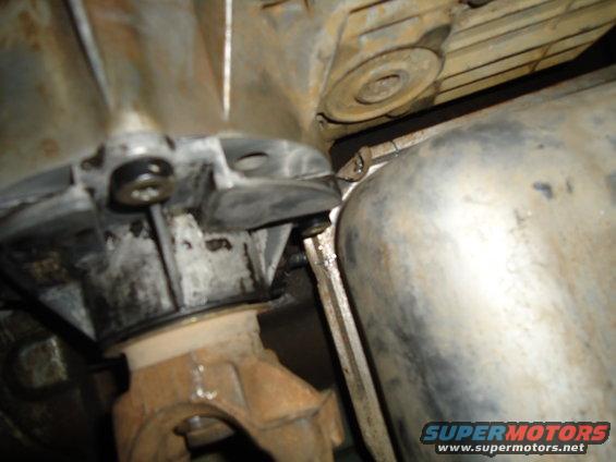 Close-up of drivetrain components, including a driveshaft and exhaust pipe