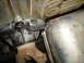 1987 Ford F-150 - Underside view of vehicle drivetrain components, showing the driveshaft and part of the exhaust system.