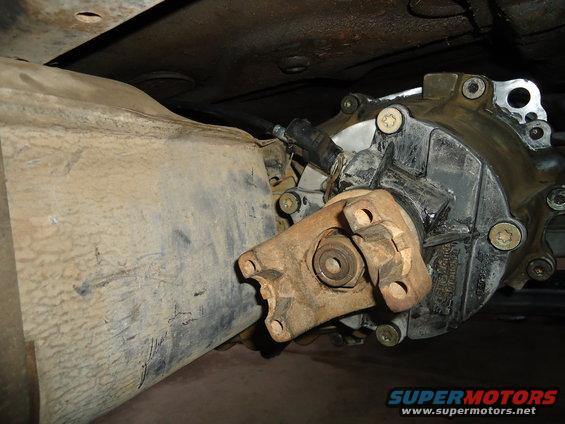 Close-up of a vehicle's transfer case and driveshaft connection