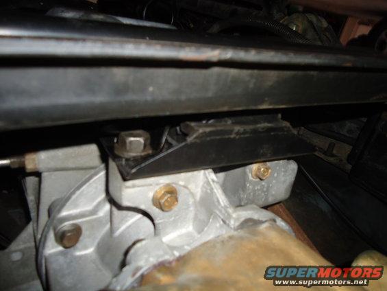 Close-up of a metal bracket bolted to an engine component