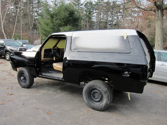 1987 Dodge 1500 SUV with doors open, being painted black and white