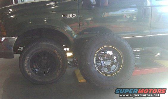 Green 2000 Ford F-350 Super Duty side view with two tires