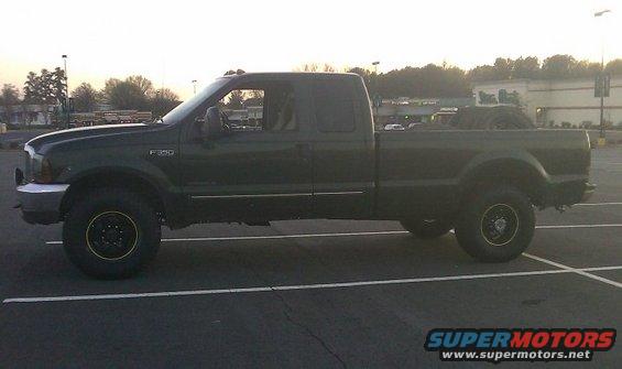 Dark green 2000 Ford F-350 Super Duty pickup truck, side view. F-350 badge visible on fender