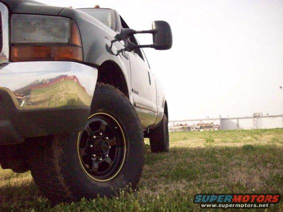 Dark gray 2000 Ford F-350 truck, front quarter view, parked on grass with a chrome bumper and black wheels