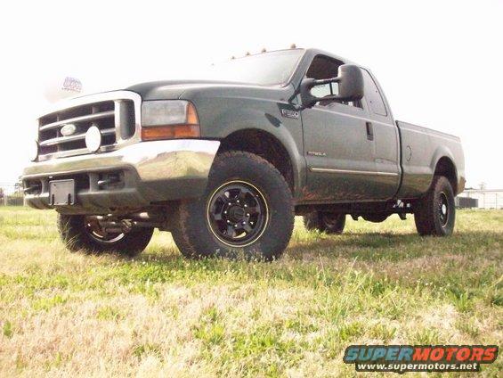 Green Ford F-250 pickup truck, front quarter view, parked on grass. Has black wheels and chrome bumper