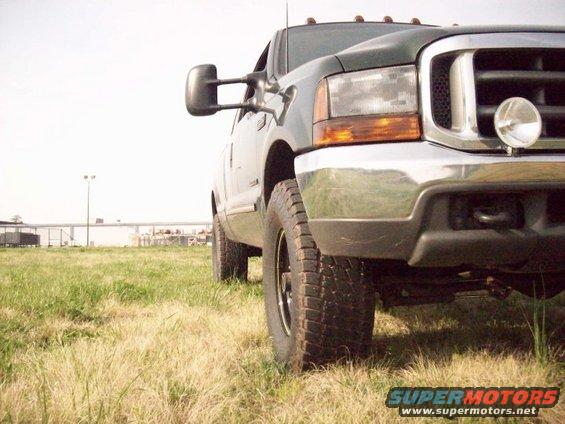2000 Ford F-350 truck parked in a grassy field, front quarter view