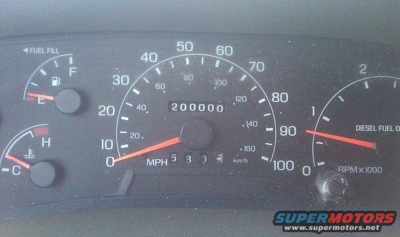 Dashboard gauges showing 200,000 miles, fuel, and temperature