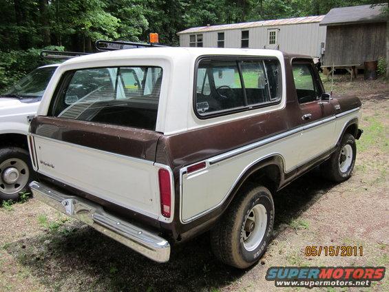 1978 Ford Bronco, two-tone brown and white, parked outdoors next to a white truck