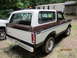 1969 Ford Mustang - Rear view of a 1978 Ford Bronco, parked next to another vehicle in a yard.