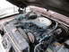 1969 Ford Mustang - The engine bay of a vehicle is shown with various components and hoses.