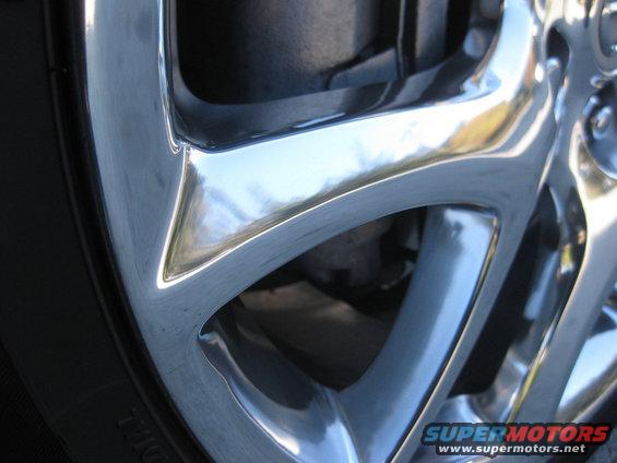 Close-up of a shiny chrome wheel with a multi-spoke design