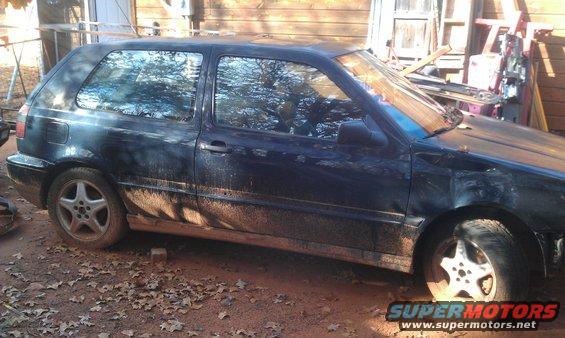 Dark blue hatchback side view, muddy
