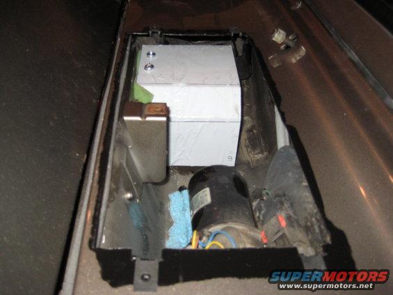 Custom metal tank and motor assembly installed in a vehicle's interior compartment