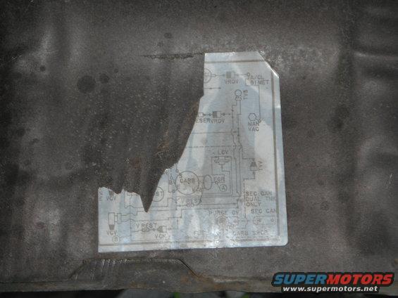 Engine vacuum diagram sticker on dark surface