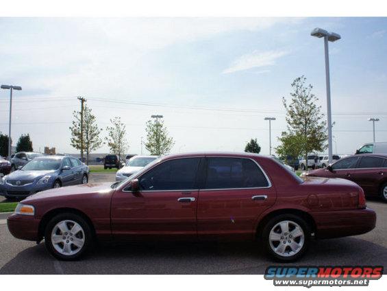 Red 2003 Ford Crown Victoria sedan, side view