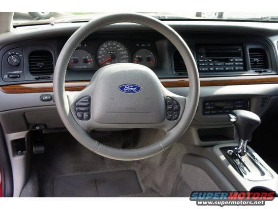 2003 Ford Crown Victoria interior with wood trim and Ford steering wheel