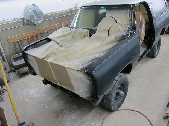 1987 Dodge 1500 truck in body shop, hood and fenders taped off for paint
