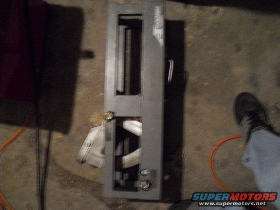 Gray metal part with rectangular openings and a handle