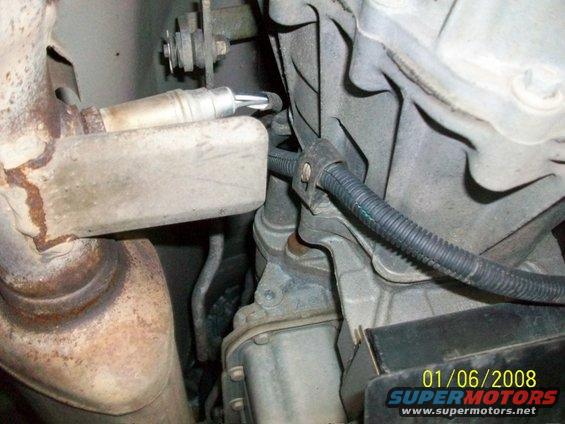 Exhaust pipe and oxygen sensor near engine block with date stamp 01/06/2008