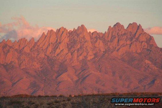 Desert landscape with jagged mountains at sunset